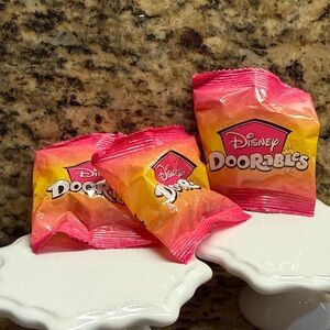 Three unopened TechnicoDisney Doorables Surprise Pack - Pink and Yellow Gradient